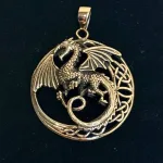 Vikingevedhæng i Bronze - Drage med Vinger i Cirkel, måne, drage, magisk, væsen, fabeldyr, eventyr, styrke, stærk, vogter, luftdrage, dragevinger, puf, cirkel, stort, rundt, smykke, bronze, kobber, guld, gyldent, vikingesmykke, vikingevedhæng, gammelt, historisk, kopi, fund, originalt, flot, rollespil, gave, amulet, dragon, sejt, særligt, gaveide, biti, ribe, museums, bra830,