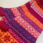 Pulsvarmere i Blød Alpaka Uld - Mikaela Rød Lilla, muffedisser, mikaela, redwine, pink, lilla, orange, alpaka, uld, luksus, fingerløse, fingerfri, mobilhandsker, mobilvanter, kulørte, luksuriøse, sjove, frække, friske, farverige, tynde, varme, smarte, søde, vanter, handsker, vinter, tilbehør, julegave, gave, uldne, fintstrikkede, mønsterstrik, uldhandsker, dame, pige, muntre, biti, ribe, lamauld