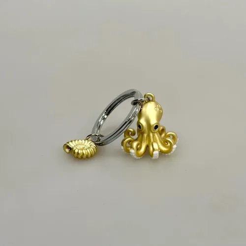 Nøglering Gylden Blæksprutte og Sneglehus, octopus, blæksprutte, havet, havdyr, ocean, ottearmet, havbiolog, marinebiolog, marine, symbolsk, biologi, biolog, nature, nytting, lækker,særlig, symbolsk, akvarium, blå planet, biti, ribe