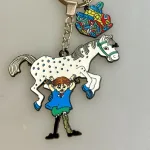 Nøglering - Pippi Langstrømpe med Hesten og Guldpengene, kuffert, hest, lilla gubban, hesten, prikket, pony, pippi123C ridning, hr. nelson, kager, kalas, bager, konditor, den store bagedyst, symbolsk, konfirmation, konfirmand, elsker, at, gave, ide, penge, asrid lindgren, stærk, god, sød, biti, ribe, metalnøglering, emaljeret, kulørt, farverig, flot, verdens stærkeste pige, rig og god, sød