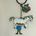 Nøglering - Pippi Langstrømpe med Hesten og Guldpengene, kuffert, hest, lilla gubban, hesten, prikket, pony, pippi123C ridning, hr. nelson, kager, kalas, bager, konditor, den store bagedyst, symbolsk, konfirmation, konfirmand, elsker, at, gave, ide, penge, asrid lindgren, stærk, god, sød, biti, ribe, metalnøglering, emaljeret, kulørt, farverig, flot, verdens stærkeste pige, rig og god, sød